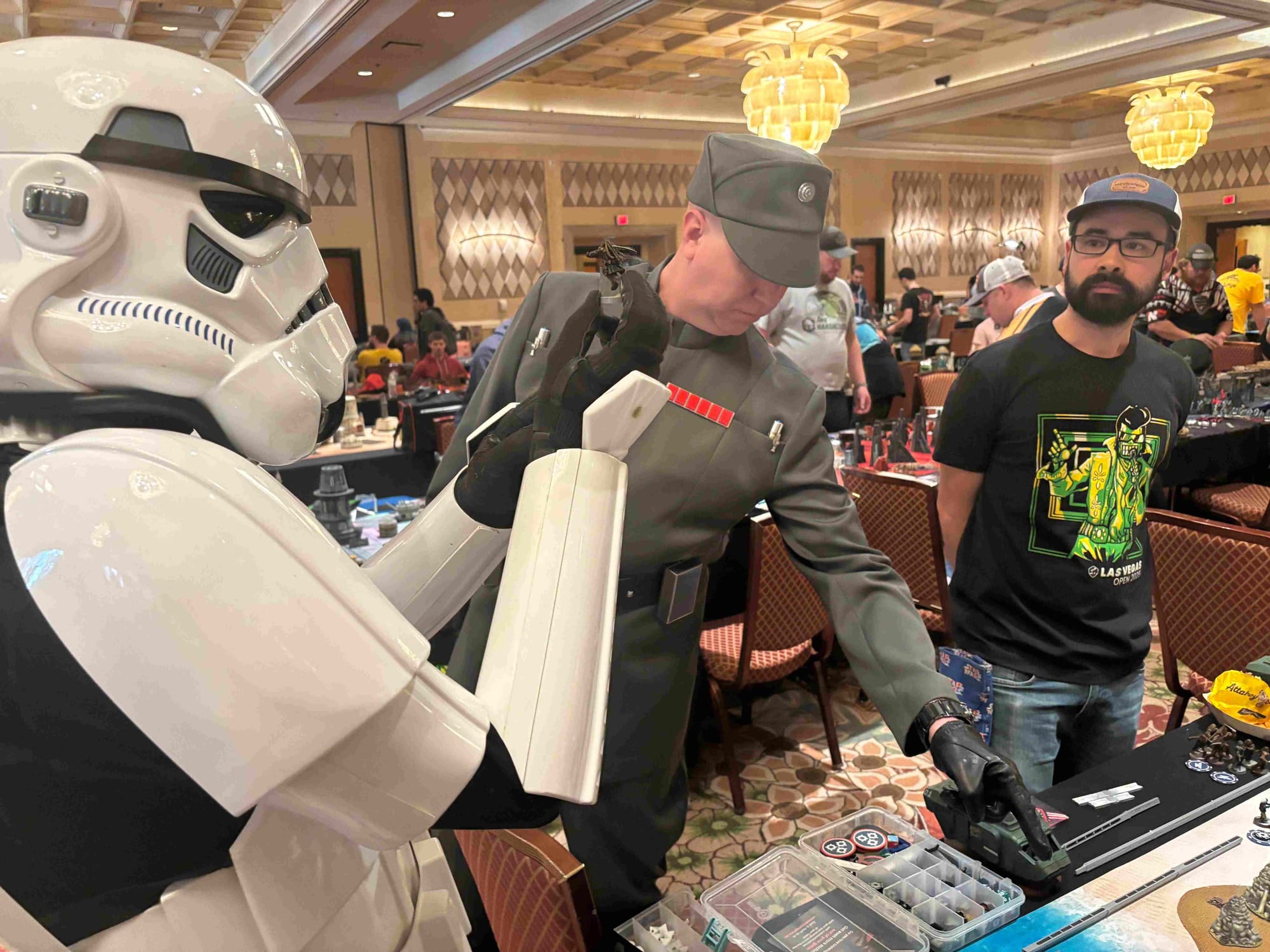 Two Star Wars Imperial cosplayers inspecting a Wookiee miniature.