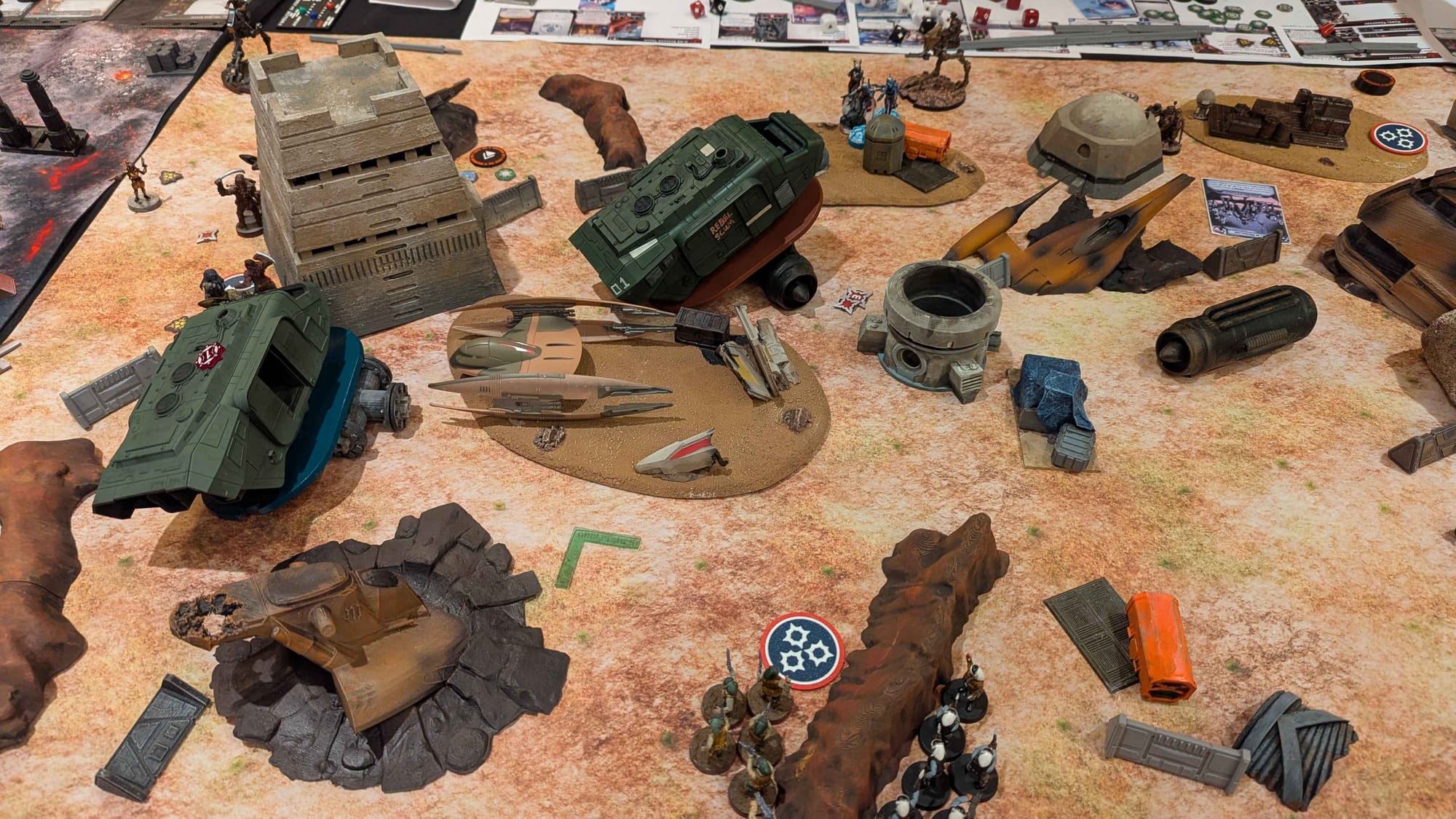 Photo of a game of Star Wars Legion featuring two A-A5 Speeder Trucks and Rebel Mandalorians.